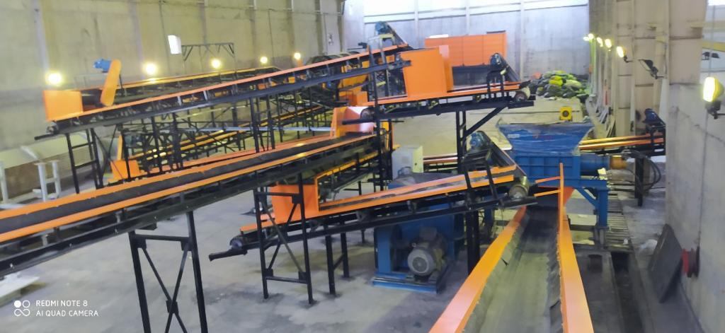 Orange conveyors on a sorting line at a partner facility