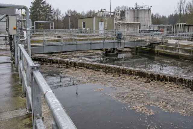 Wastewater treatment clarifier with floating sludge at an industrial treatment site